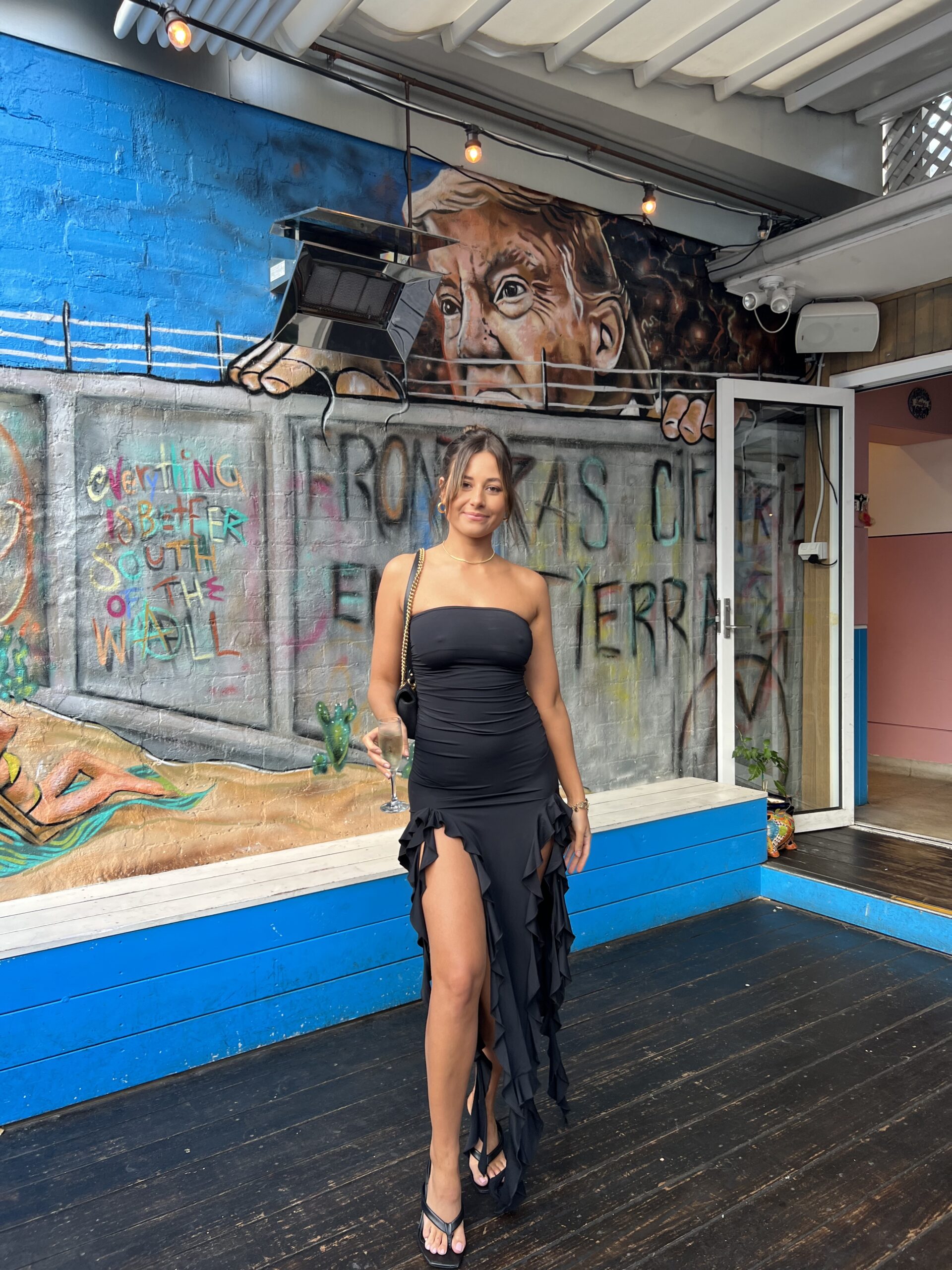 Lioness Rendezvous black ruffle strapless midi dress for rent.